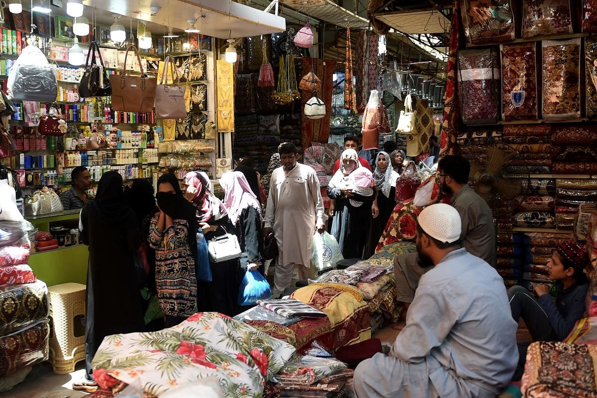 People shop at a market after the government eased a nationwide lockdown imposed as a preventive measure against the COVID-19 coronavirus, in Karachi on May 19, 2020. Credit: AFP Photo