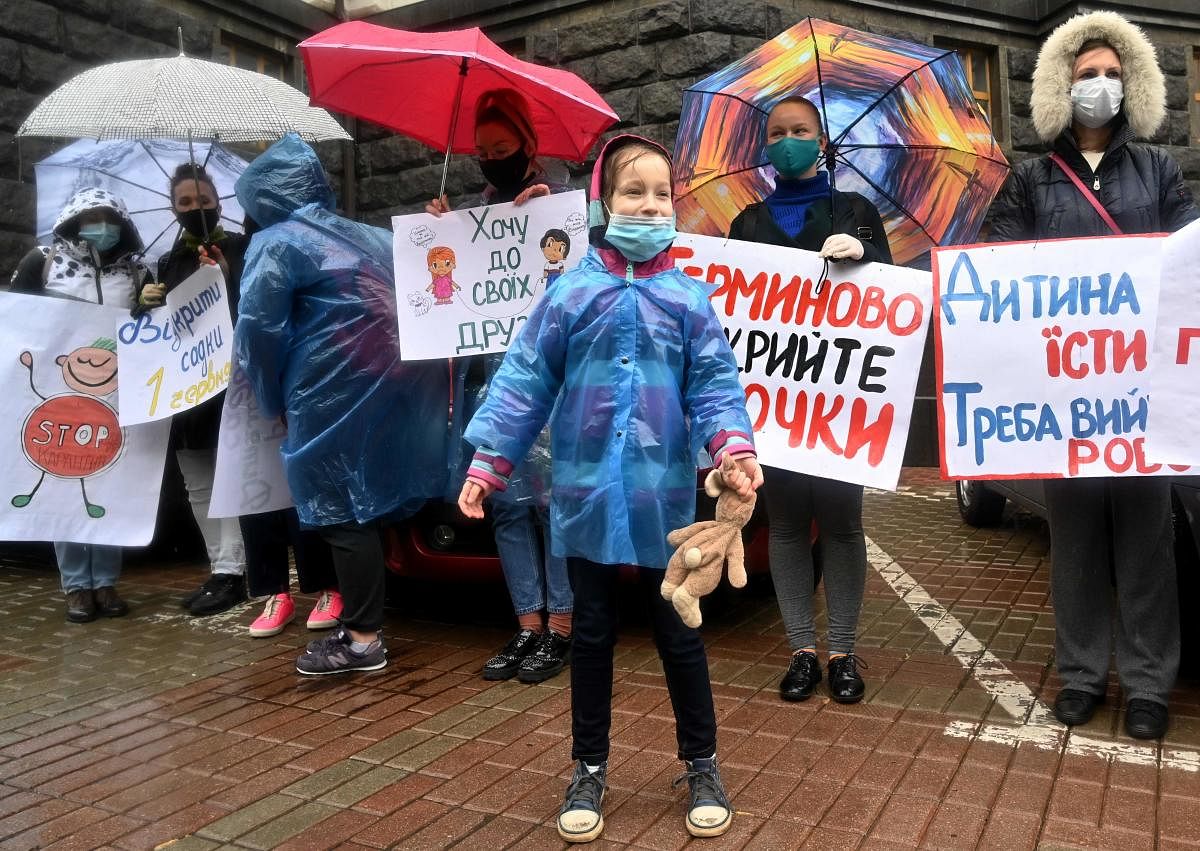 Parents of kindergarten-age children rally demanding to ease anti-virus restrictions and reopen kindergartens outside the Ukrainian Cabinet of Ministers headquarters in Kiev on May 19, 2020. Credit: AFP Photo