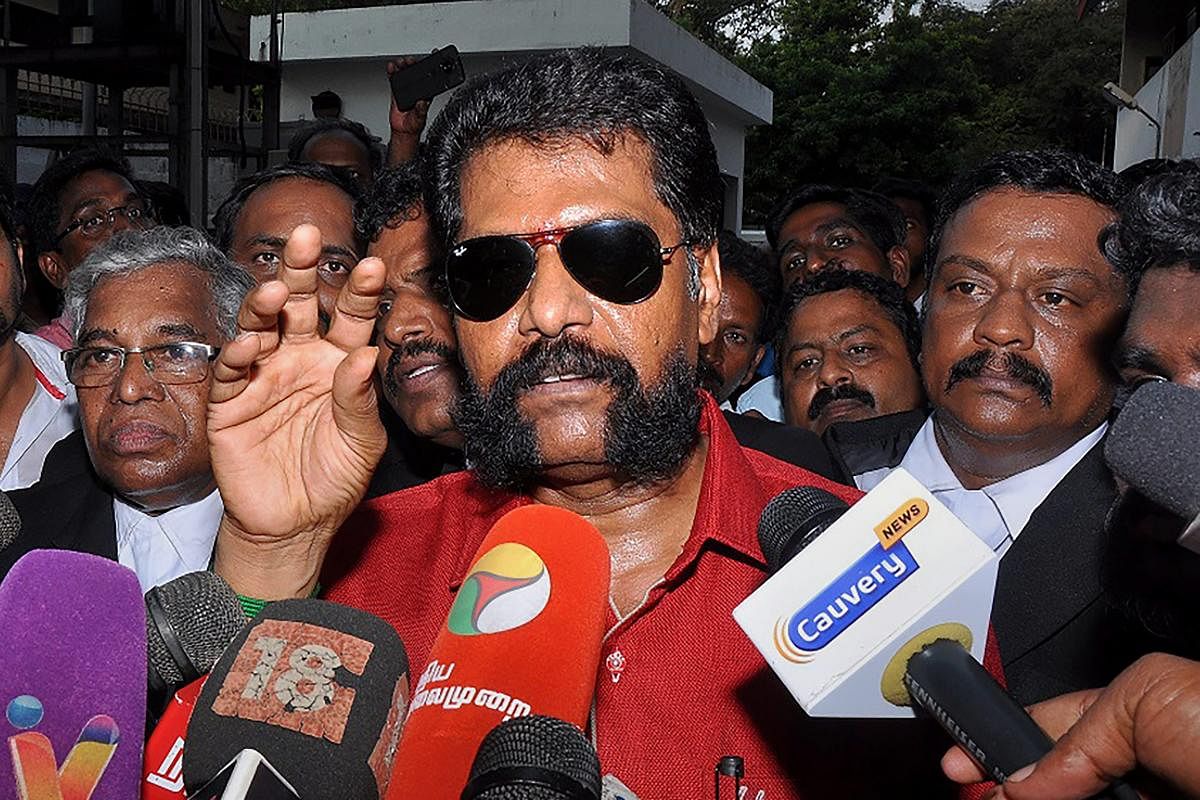 Senior journalist R Gopal, who heads the Tamil weekly magazine 'Nakkheeran', addresses the media as he is being taken to court, in Chennai. (PTI photo)