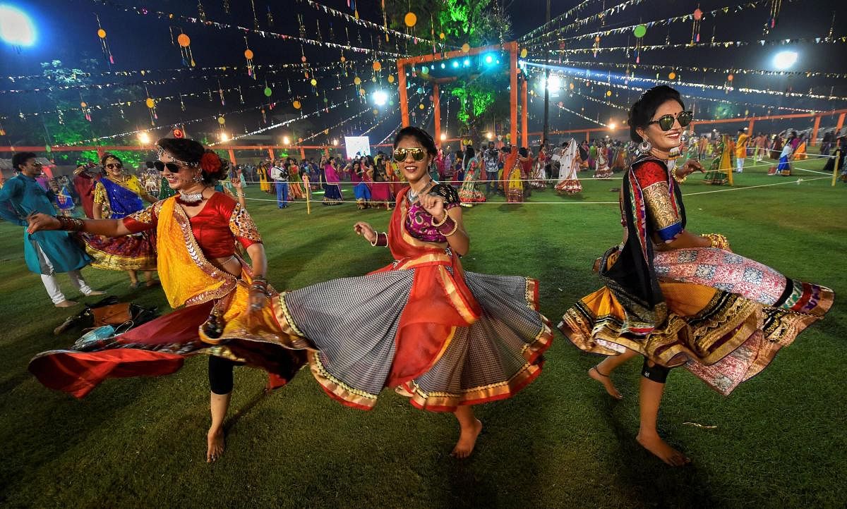 Youngsters dressed in traditional attire participate in the traditional folk dance 'Garba' on the first day of nine-day Navratri festival, in Ahmedabad. (PTI photo)