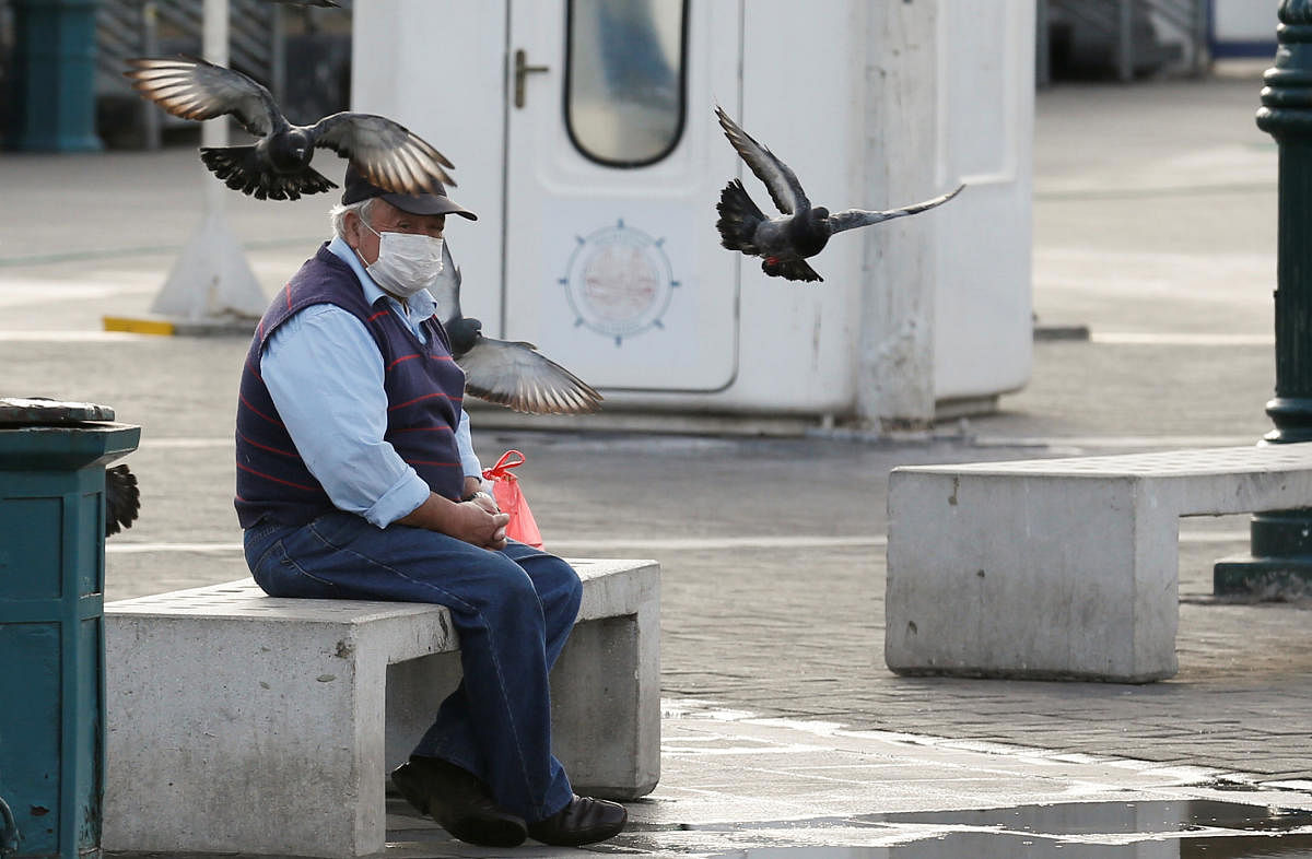 A man wearing a protective face mask as a precaution against the spread of the coronavirus disease (COVID-19) rests in a public square in Valparaiso, Chile. (Reuters photo)