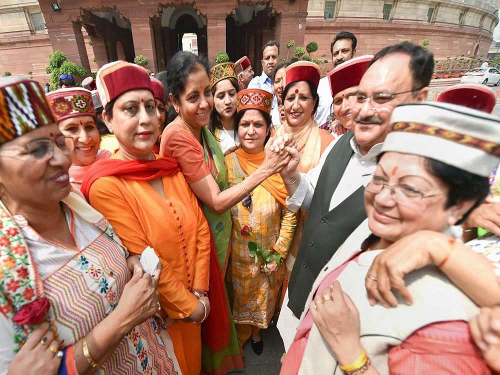 Defence Minister Nirmala Sitaraman and Health Minister JP Nadda with women visitors from Himachal Pradesh at Parliament house in New Delhi on Wednesday. PTI Photo