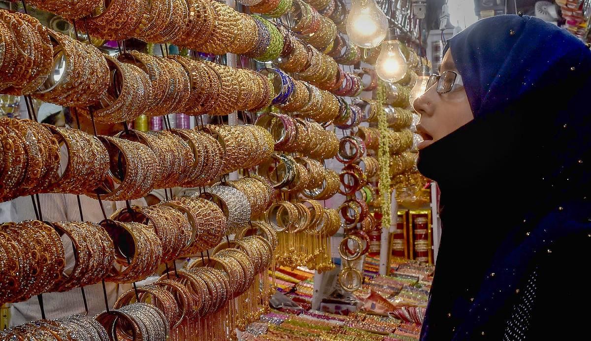 Muslim woman buys ornaments ahead of Eid al-Fitr, in Kolkata on Wednesday. PTI Photo