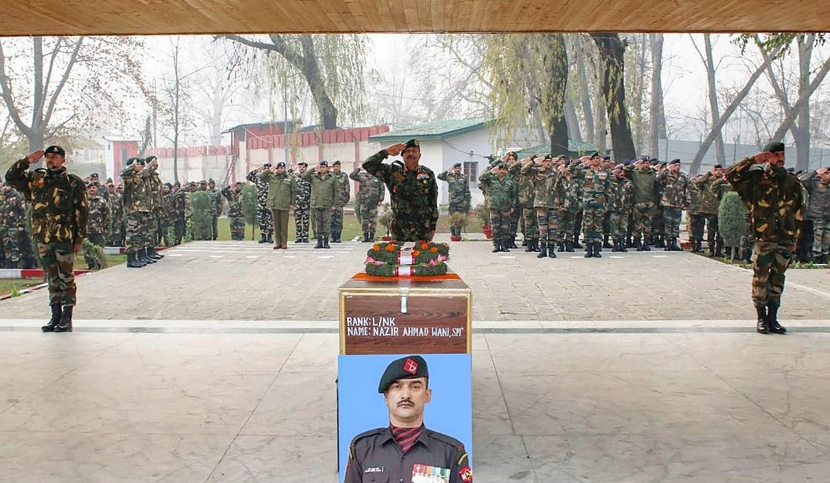 Kulgam: Army personnel pay tribute to L/NK Nazir Ahmad of 34 RR, who lost his life while fighting terrorists in Shopian, at his native village, in Chak Ashmuji in Kulgam district of South Kashmir, Monday, Nov. 26, 2018. (PTI Photo)