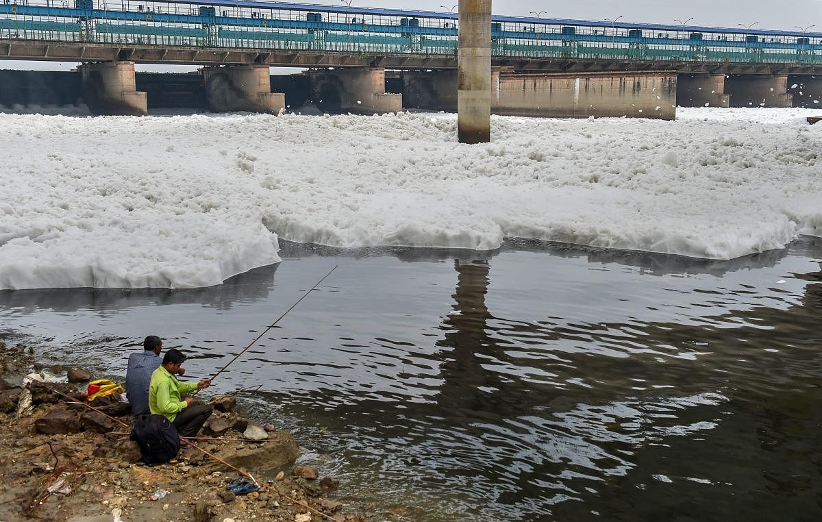 New Delhi: People fish from the polluted water of river Yamuna, in New Delhi, Sunday, Sept 23, 2018.(PTI Photo by Manvender Vashist)