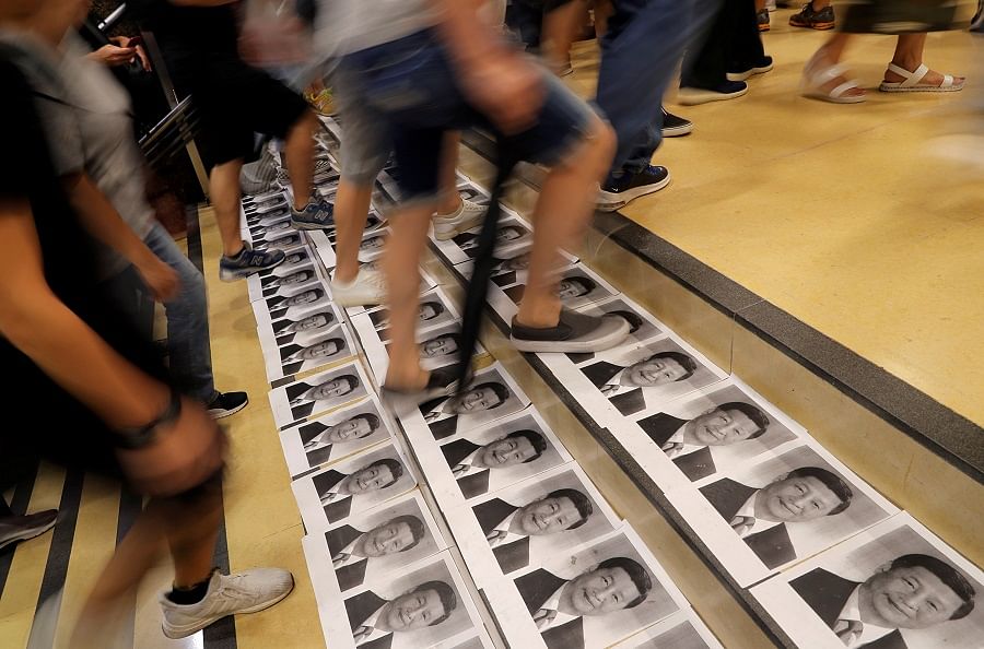 People step on Chinese President Xi Jinping's pictures at a metro station in Admiralty district, in Hong Kong, China. Reuters