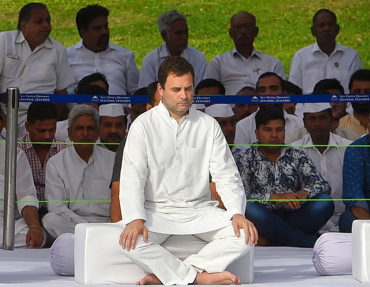 Congress President Rahul Gandhi pays tribute to India's first prime minister Pandit Jawaharlal Nehru on his 54th death anniversary, at Shanti Van, in New Delhi, on Sunday. PTI Photo