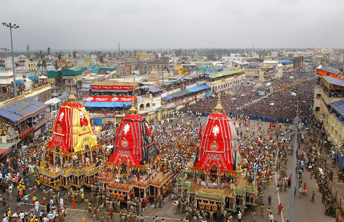 Devotees pull the chariots of Lord Jagannath, Balarama and Subhadra during the annual Rath Yatra, in Puri. (PTI Photo)