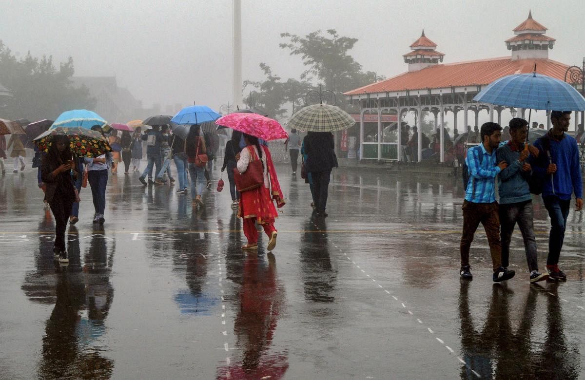 Pedestrians walk under their umbrella during monsoon rainfall, in Shimla on Monday. PTI Photo