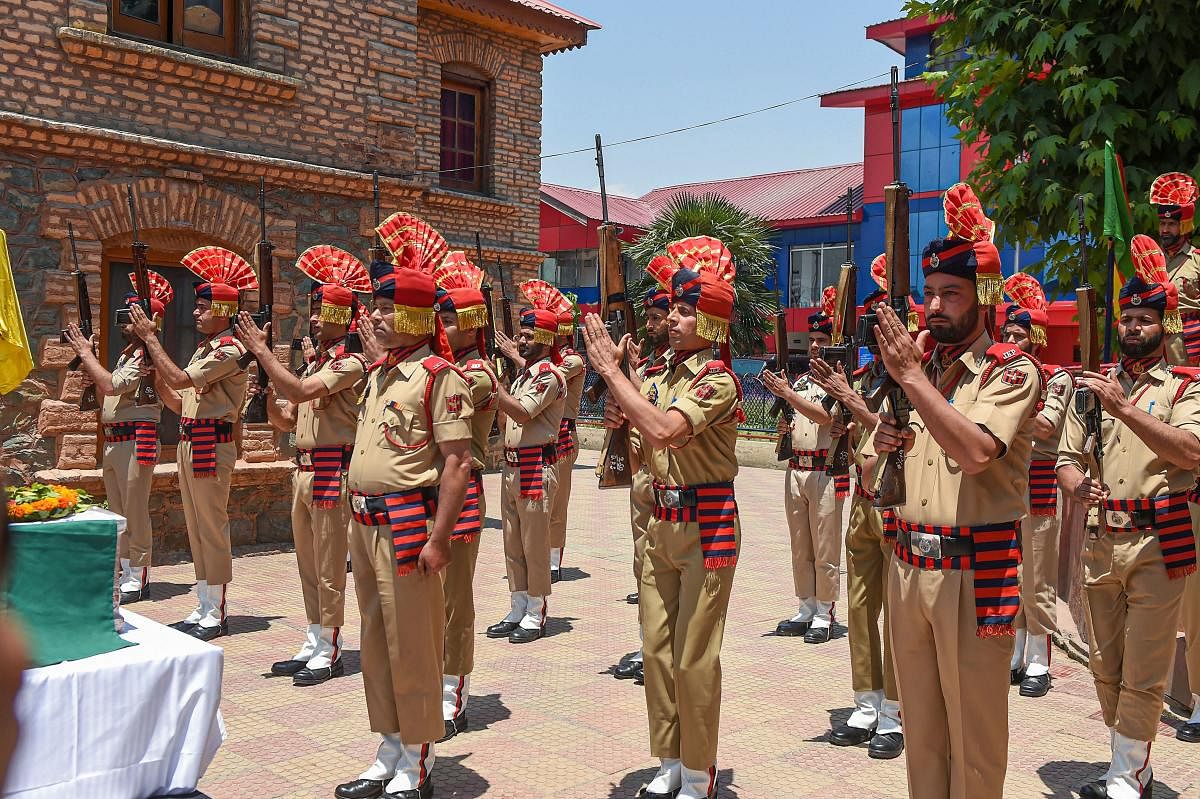 Policemen pay tribute to their colleague officer Arshad Khan during wreath-laying ceremony at District Police Lines, in Srinagar, Monday, June 17, 2019. PTI