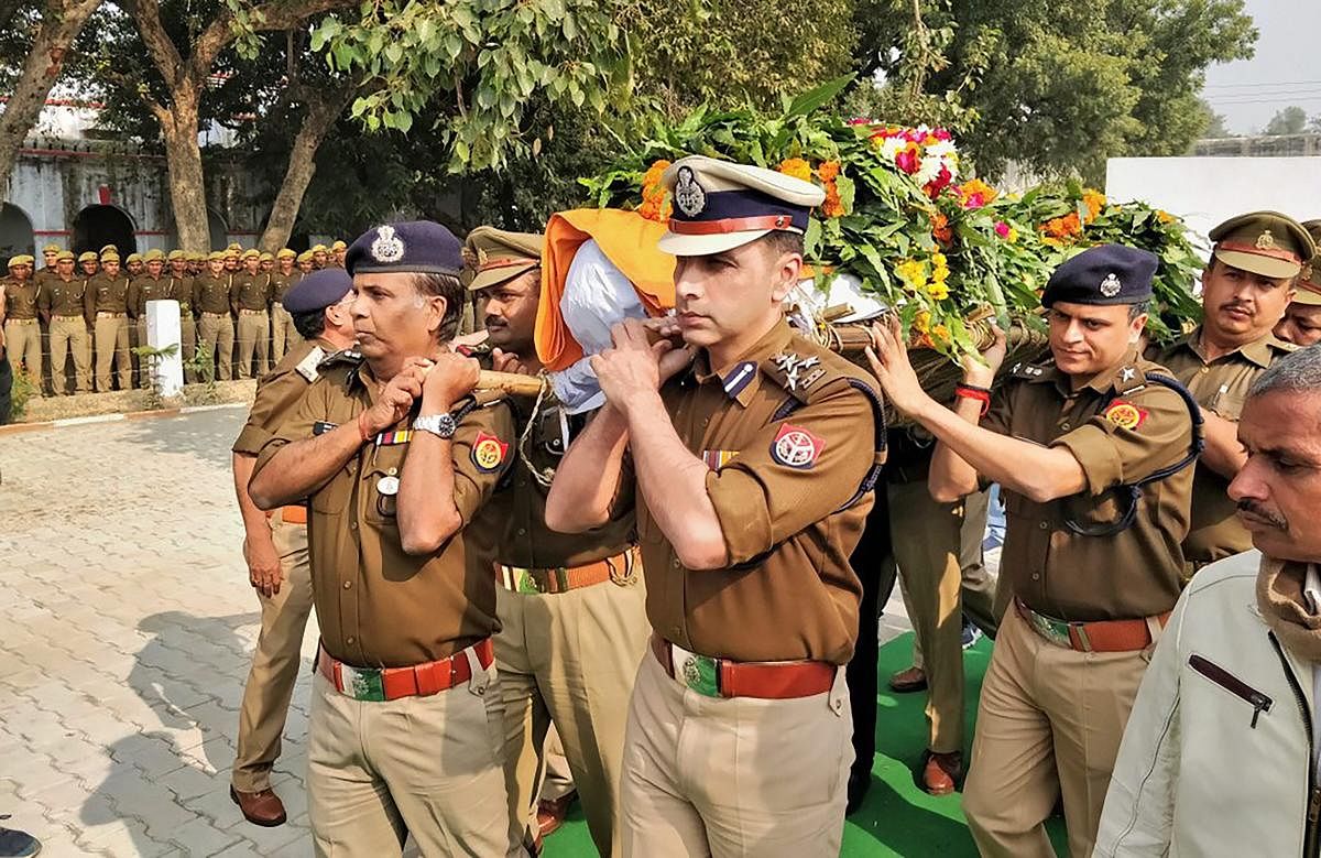 Police officials carry the mortal remains of Police Inspector Subodh Kumar Singh, after the wreath-laying ceremony in Etah. Singh was killed during violent clashes that erupted over the alleged illegal slaughter of cattle, in Bulandshahr, Uttar Pradesh. (PTI Photo)
