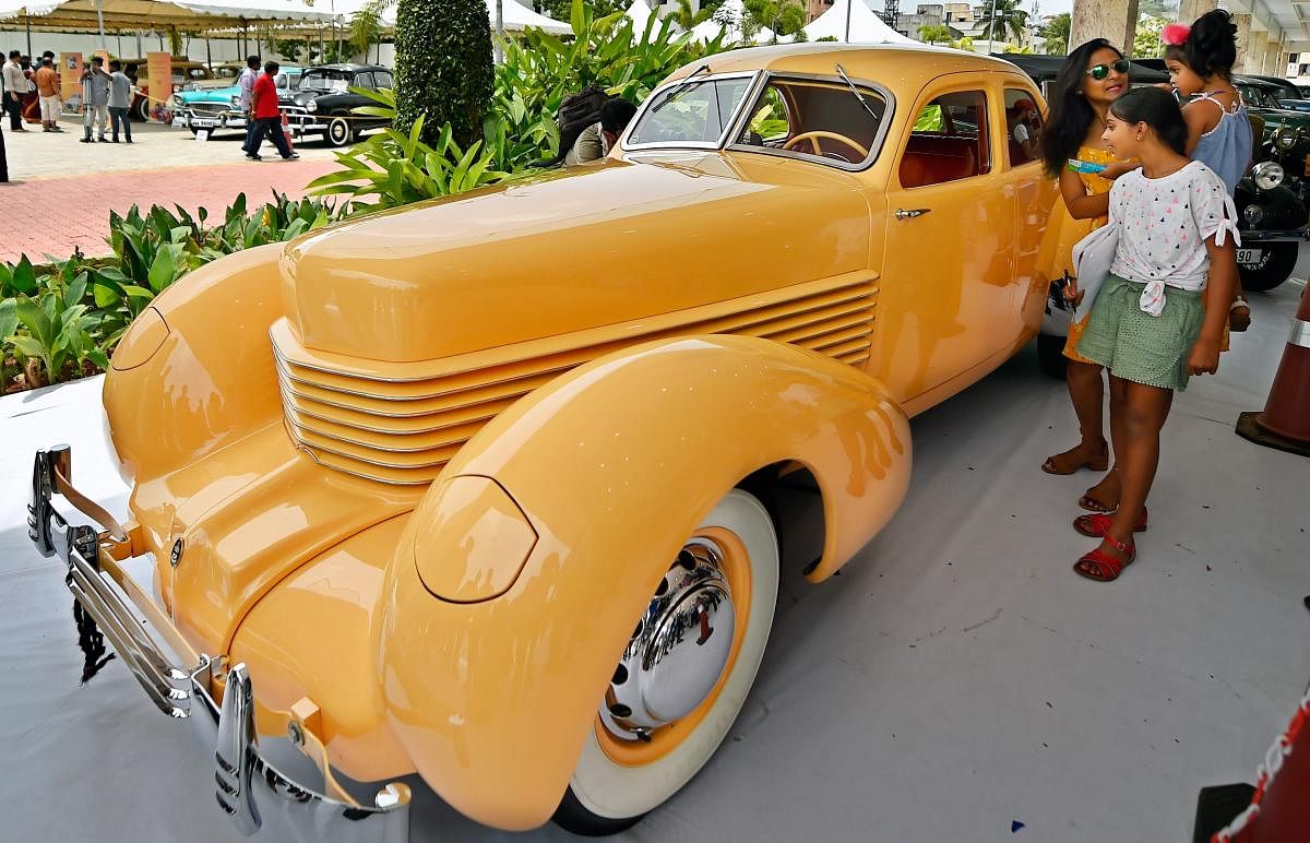 Auto enthusiasts look at a car displayed during vintage cars and motorcycles rally, in Chennai on Sunday. PTI photo