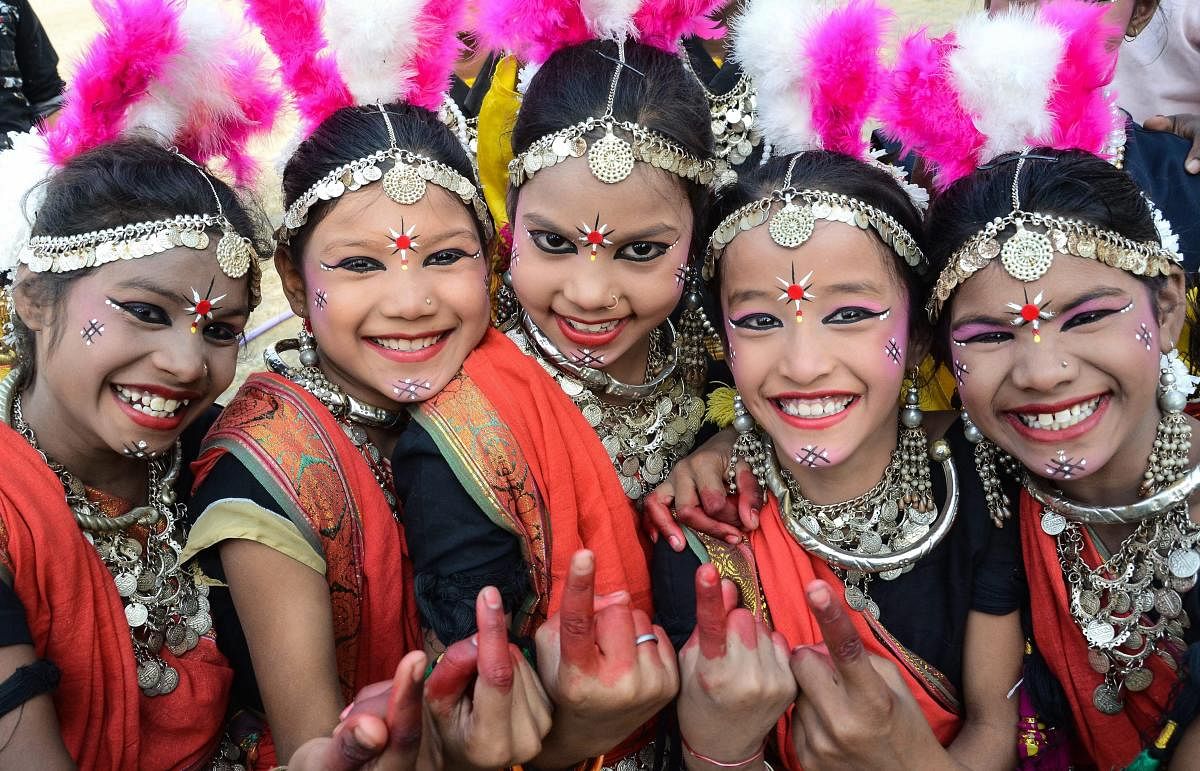 Jabalpur: Tribal children dressed in their traditional attire pose for a photograph during the Voter Awareness Campaign for Madhya Pradesh Assembly elections, in Jabalpur, Saturday, Nov. 24, 2018. (PTI Photo)