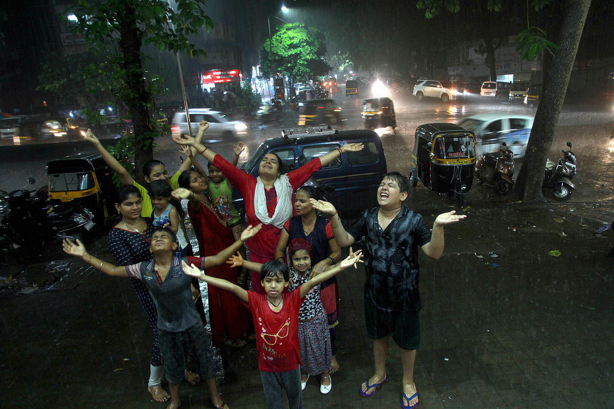 People enjoy the first shower of the season in Thane, Monday night, June 10, 2019. (PTI Photo)