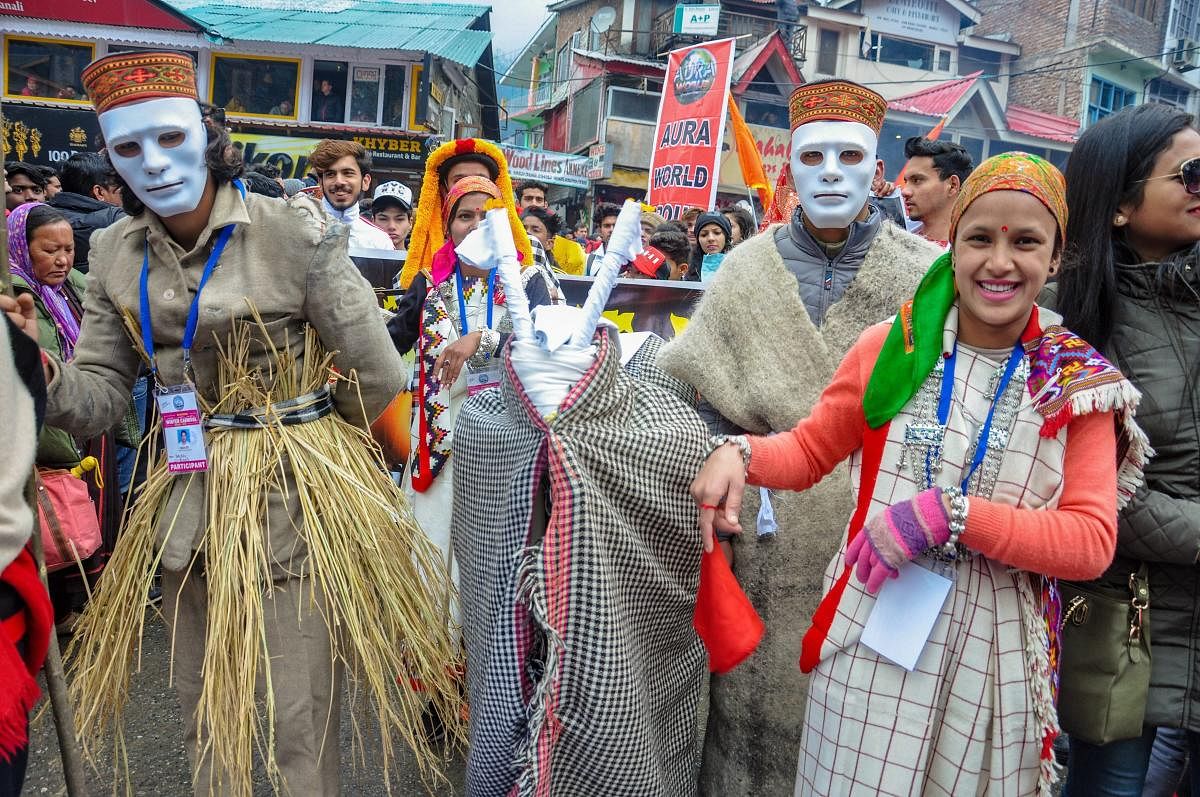 Artistes of a cultural troupe after the inauguration of a four-day winter carnival in Manali. PTI
