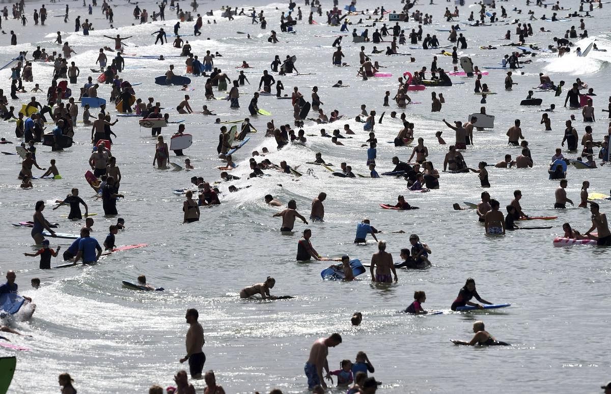 People in the sea at Woolacombe Beach as another spell of warm weather hits the UK, in North Devon, England. AP/PTI photo