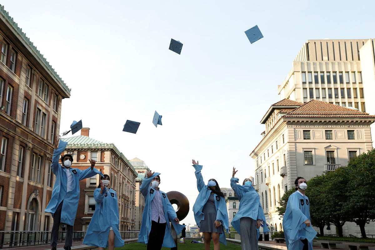 Graduating Masters students from the Columbia University Graduate School of Architecture, Planning and Preservation (GSAPP) throw their graduation caps in the air for a photo the day before their graduation ceremony, which is to be held online due to the outbreak of the coronavirus disease (COVID-19) in Manhattan, New York City, U.S. Credit: Reuters Photo
