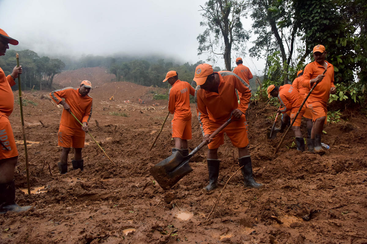 NDRF personnel dig for bodies. So far, five bodies have been recovered and five more people have been missing, in Thora village, Virajpet Taluk, Madikeri District. Photo/ B H Shivakumar