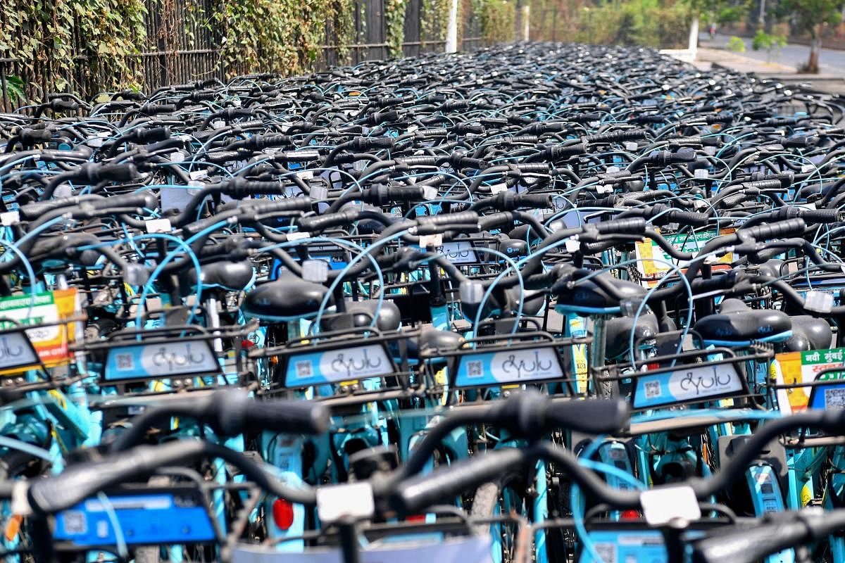 Rental bicycles are seen stacked outside a park during a government-imposed nationwide lockdown as a preventive measure against the spread of the COVID-19 coronavirus in Navi Mumbai on April 14, 2020. (Photo by AFP)