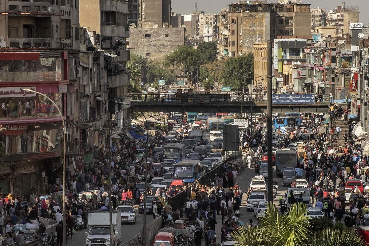 People crowd a street a few hours ahead of curfew in Cairo, Egypt, Tuesday, April 14, 2020. The government has imposed a nationwide curfew from 8 p.m. to 6 a.m due to the coronavirus outbreak. (AP/PTI Photo)