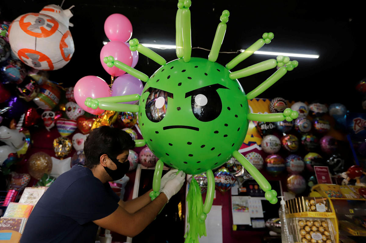 Victor Vazquez works on a balloon depicting the coronavirus at a store, as the spread of the coronavirus disease (COVID-19) continues, in Cuautlancingo, in Puebla state, Mexico April 21, 2020. (REUTERS Photo)