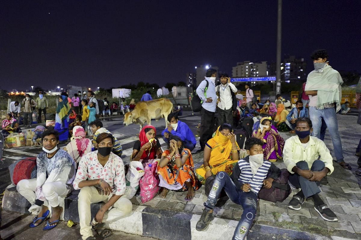 Migrants waiting for transportation to reach their destinations during the nationwide COVID-19 lockdown, in New Delhi, Thursday, May 14, 2020. (PTI Photo)