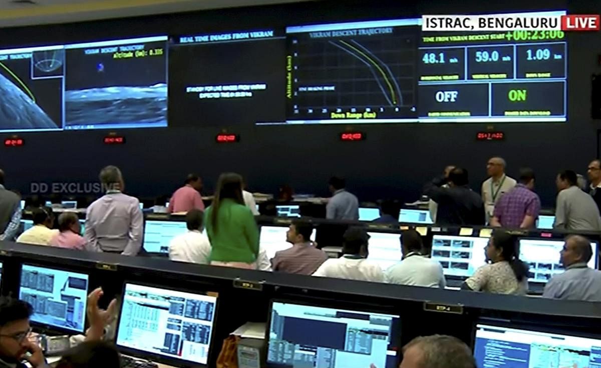Officials watch live telecast of the soft landing of Vikram module of Chandrayaan 2 on lunar surface as it starts 'fine breaking' at ISRO Telemetry Tracking and Command Network (ISTRAC), in Bengaluru, Saturday, Sept. 7, 2019. (PTI Photo)