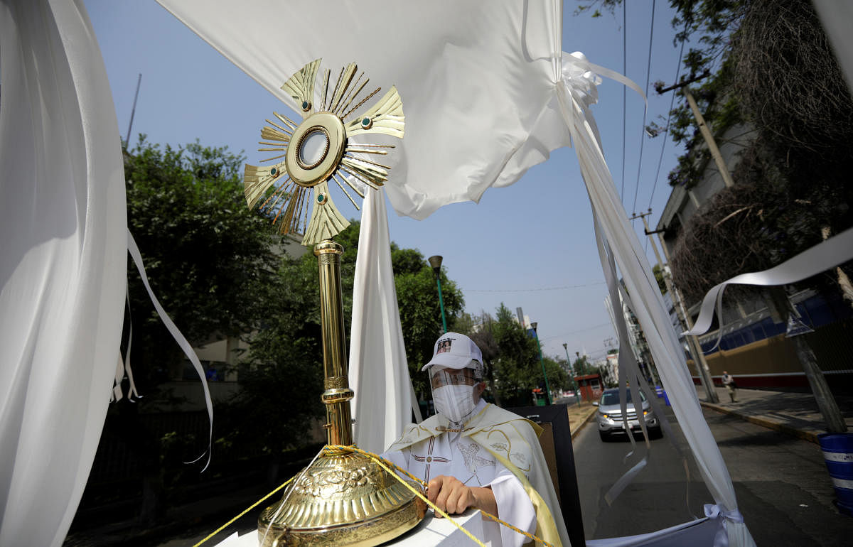 Angel Lauro Sanchez, the parish priest of the Catholic Church of the Lady of the Rosary, performs a procession in the streets with the image of the Sacrament Jesus to pray for soon dissipate the current situation of coronavirus pandemic (COVID 19), in Mexico City, Mexico April 19, 2020. Credit: Reuters Photo