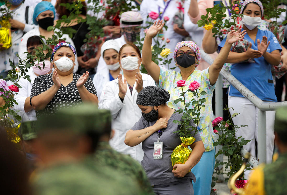 Female medical workers react as members of the Mexican National Guard Orchestra perform outside a hospital, during the Mother's Day celebrations, as the spread of the coronavirus disease COVID-19 continues, in Monterrey. Credit: Reuters Photo