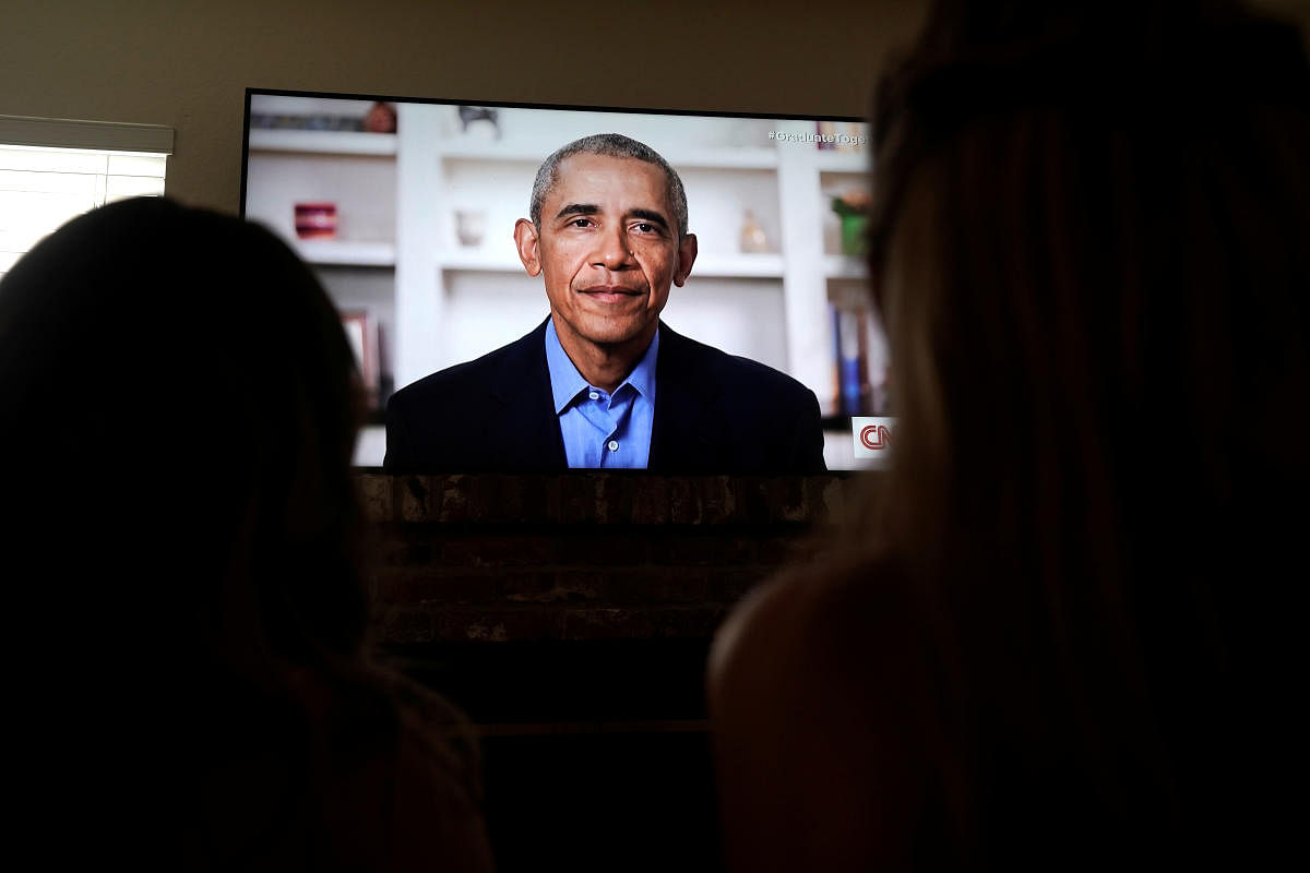 Torrey Pines High School graduating student Phoebe Seip, 18 (right), and her sister Sydney, 22, watch former United States President Barack Obama deliver a virtual commencement address to millions of high school seniors who will miss graduation ceremonies due to the coronavirus disease (COVID-19) outbreak, while celebrating Phoebe?s canceled prom night at home in San Diego, California, U.S. Credit: Reuters Photo