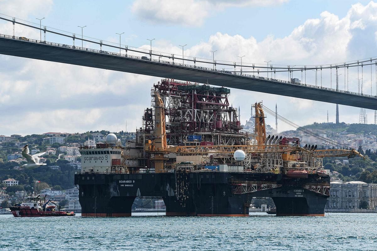 Scarabeo 9, a 115-meter-long and 78-meter-high Frigstad D90-type semi-submersible drilling rig, passes under the July 15th Martyrs Bridge (Bosphorus Bridge) on the Bosphorus Strait en route to the Black Sea in Istanbul on August 29, 2019. (Photo by Ozan KOSE / AFP)