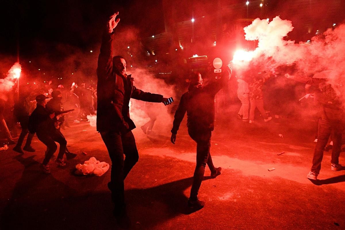 PSG's supporters celebrate at the end of the UEFA Champions League round of 16 second leg football match between Paris Saint-Germain (PSG) and Borussia Dortmund, outside the Parc des Princes stadium, in Paris. (AFP Photo)