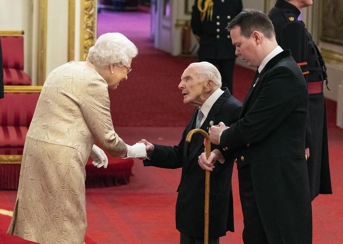 Britain's Queen Elizabeth wears gloves as she awards the MBE (Member of the Order of the British Empire) to Harry Billinge from St Austell, during an investiture ceremony at Buckingham Palace in London, Tuesday March 3, 2020. Buckingham Palace declined to confirm whether the Queen was taking the precaution because of the coronavirus outbreak. AP/PTI