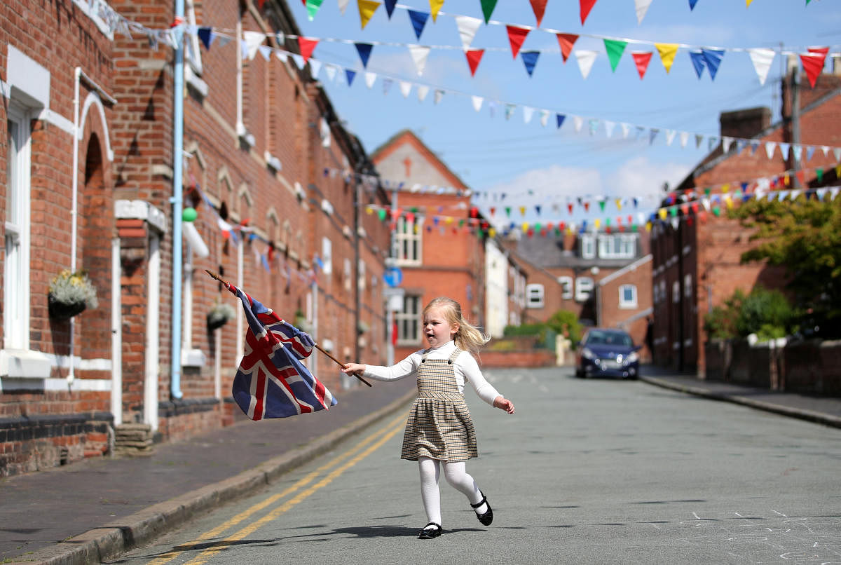 A young girl with a flag on Cambrian Road on the 75th Anniversary of VE Day, Chester, Britain. Credit: Reuters Photo