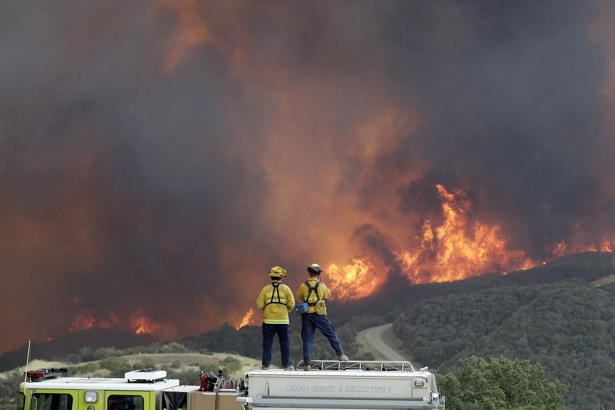 Lakeport : A fire crew from San Luis Obispo County keeps an eye on an advancing wildfire from the perimeter of a residence Tuesday, July 31, 2018, in Lakeport, Calif. Evacuation orders remained in effect Tuesday for the town of Lakeport, the county seat, along with some smaller communities and a section of the Mendocino National Forest. AP/PTI Photo