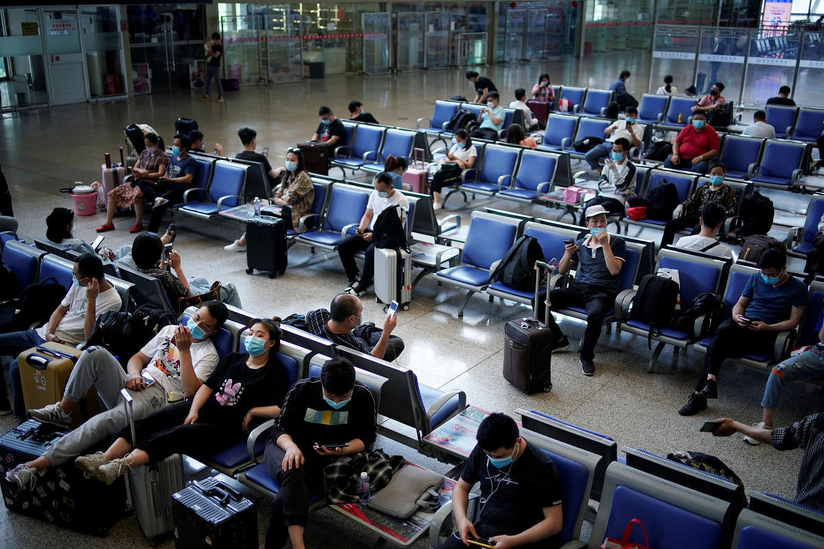 People wearing face masks are seen at Wuhan Railway Station, in Wuhan, the Chinese city hit the hardest by the coronavirus disease (COVID-19) outbreak, in the Hubei province, China, May 17, 2020. Credit: Reuters File Photo