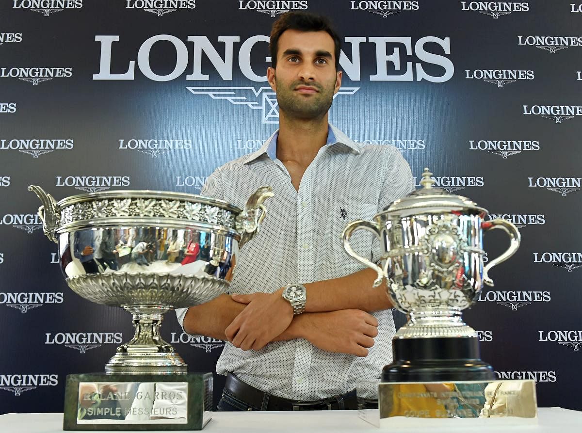 Indian tennis player Yuki Bhambri poses for a photo with Roland-Garros trophy in New Delhi on Thursday. PTI Photo