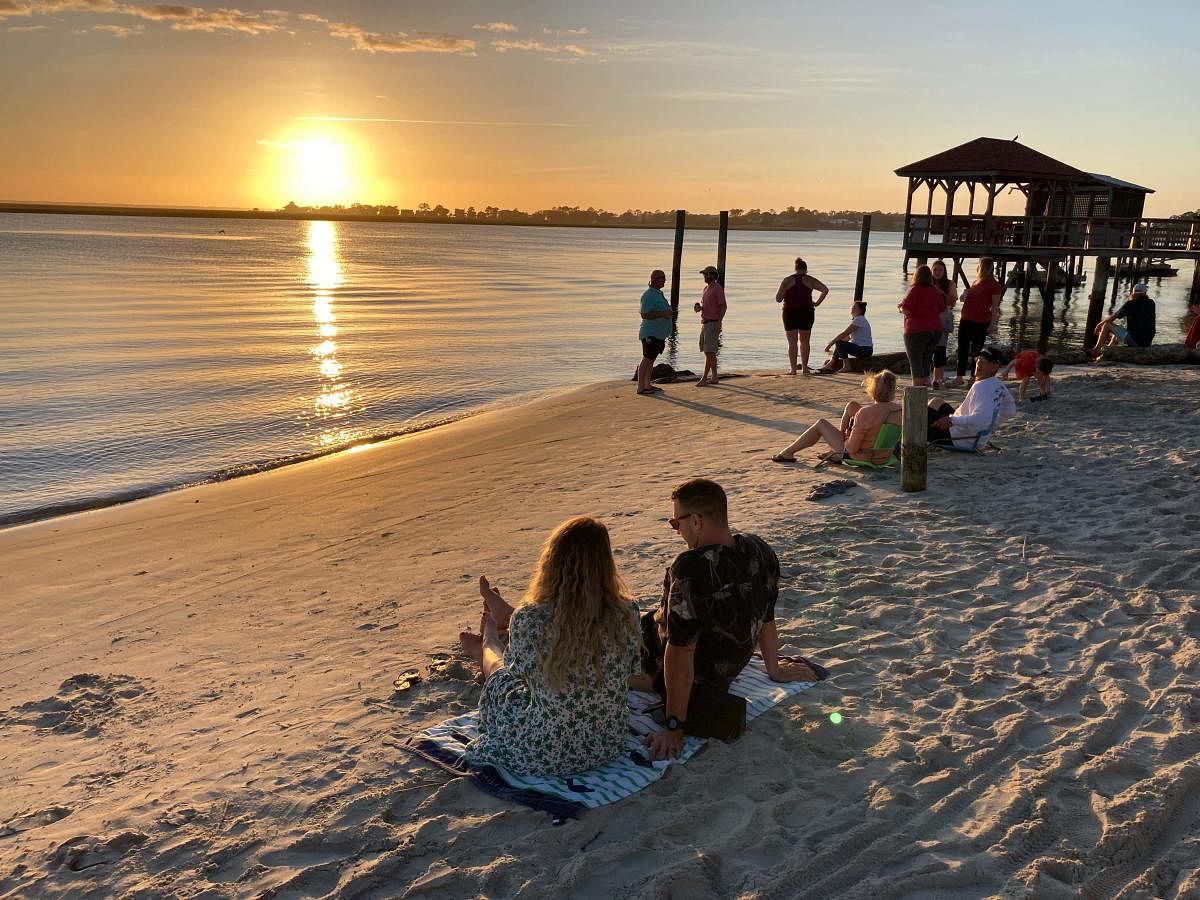 People watch the sunset on Tybee Island, near Savannah, Georgia. (AFP Photo)