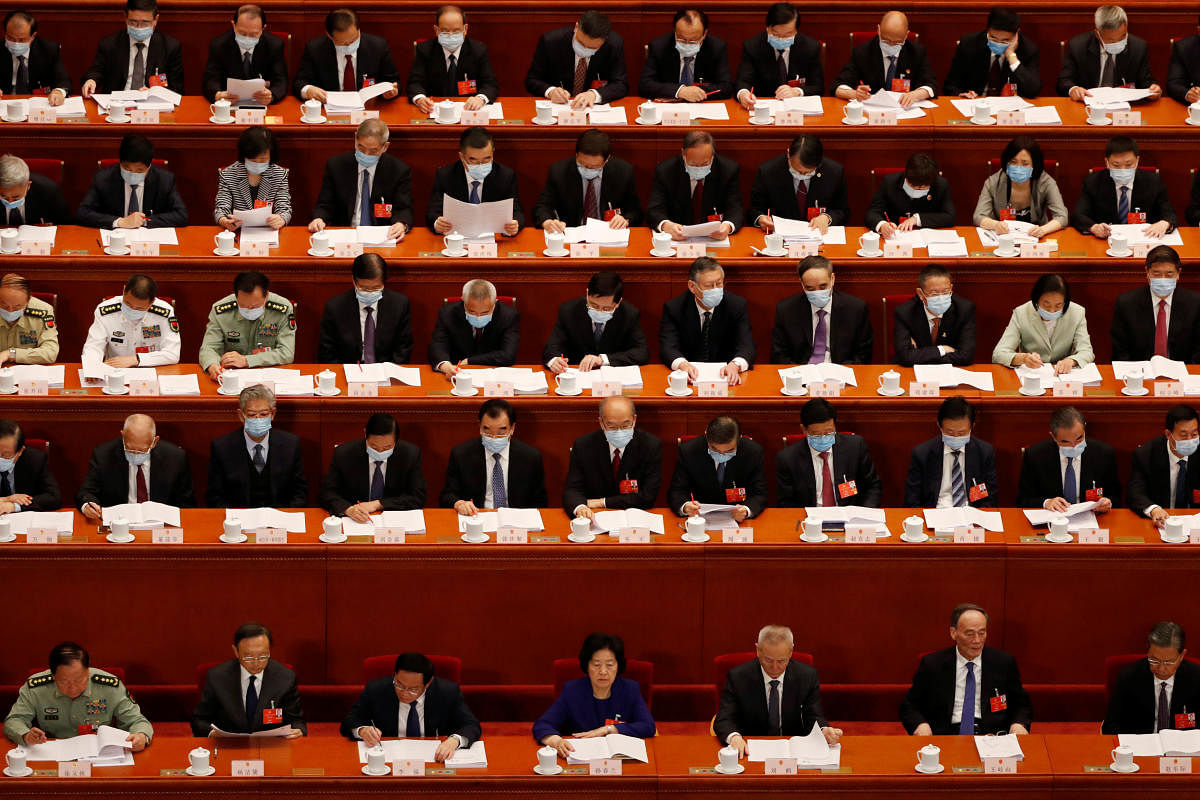 Chinese officials, some wearing face masks following the coronavirus disease (COVID-19) outbreak, attend the opening session of the National People's Congress (NPC) at the Great Hall of the People in Beijing, China. (Reuters photo)