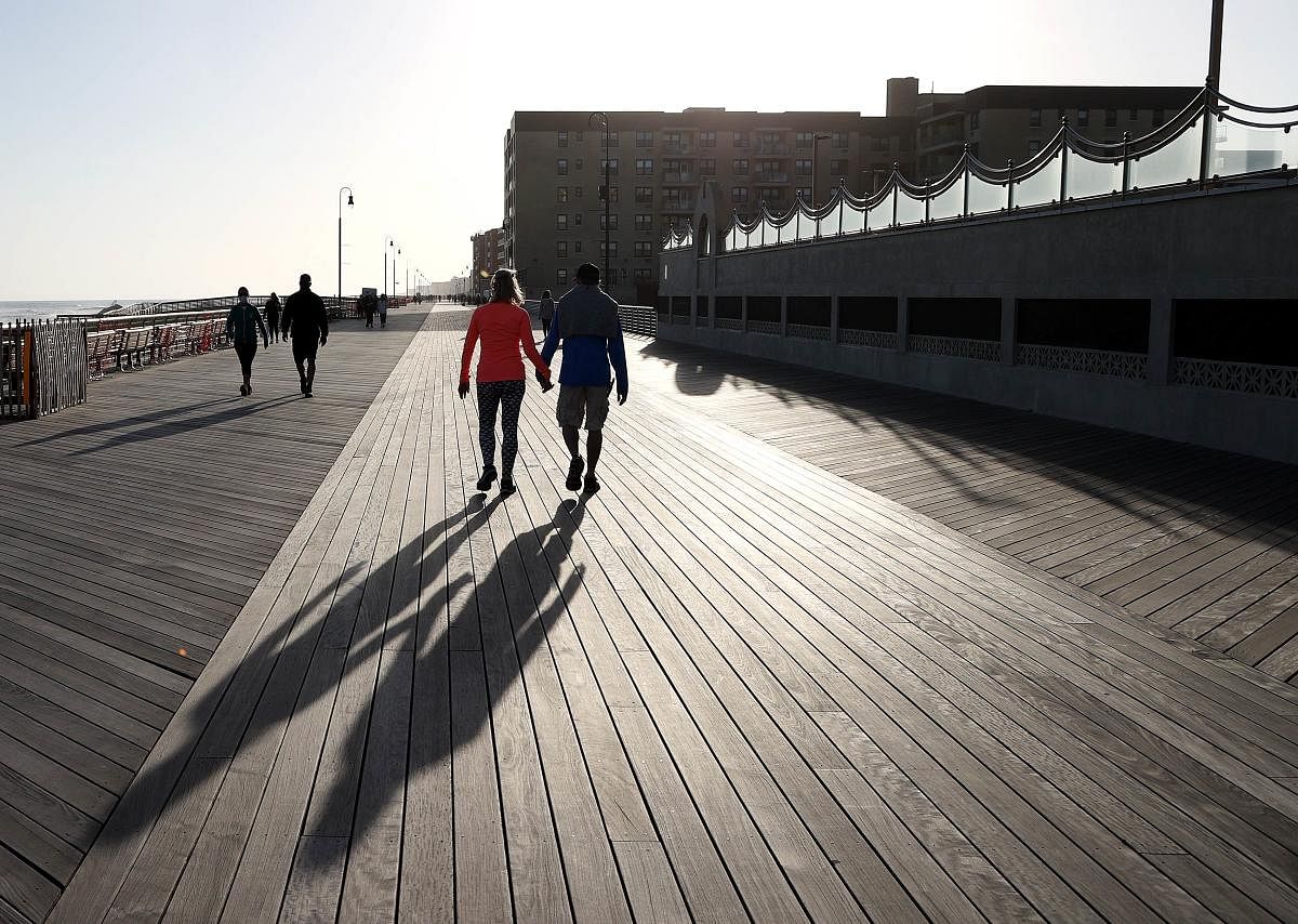 Visitors take to the boardwalk which reopened in Long Beach, New York. (AFP Photo)