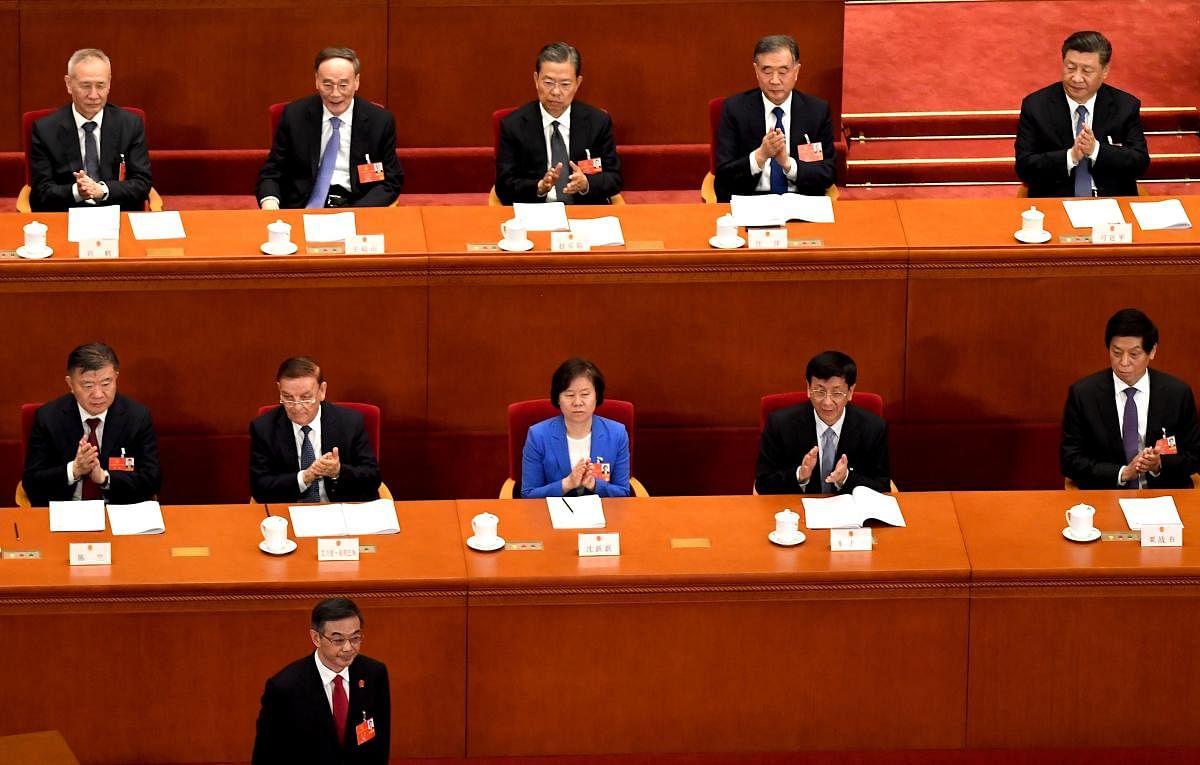 Supreme People’s Court President (bottom L) bows during the second plenary session of the National People’s Congress in the Great Hall of the People in Beijing on May 25, 2020. (Photo by Noel CELIS / AFP)