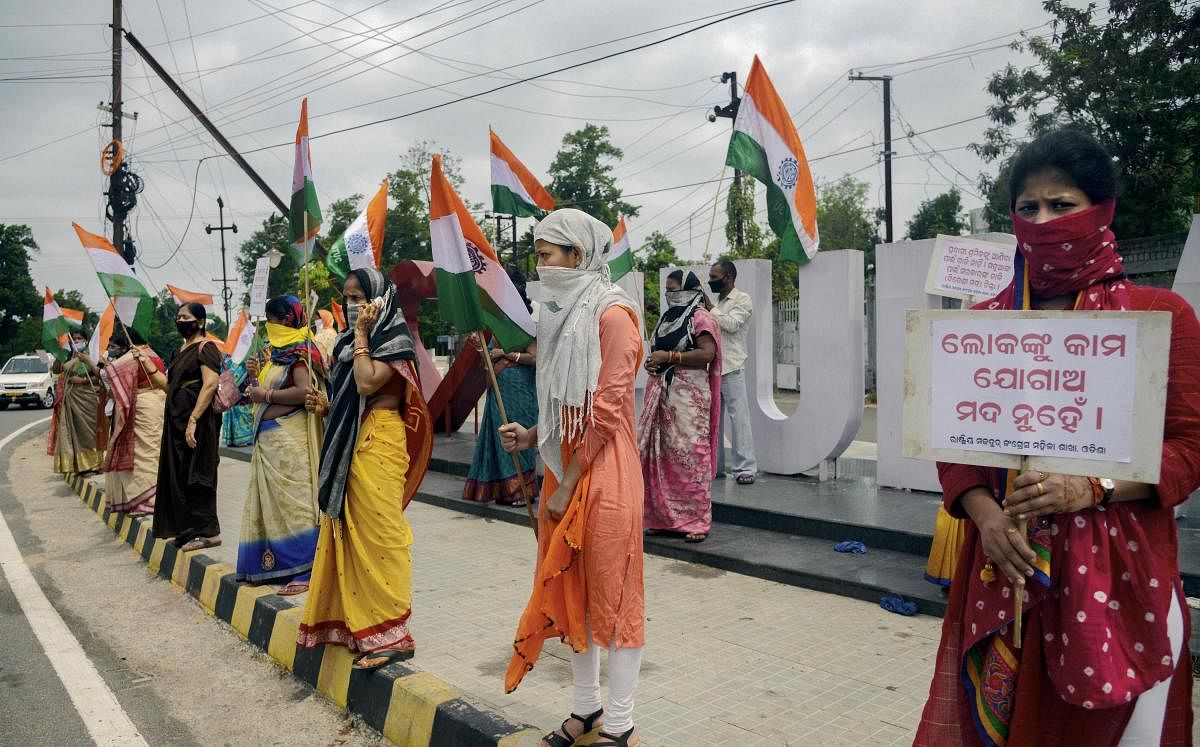Rashtriya Mazdoor Congress members stage protest against state government's decision to open liquor sale online, amid ongoing COVID-19 lockdown in Bhubaneswar, Monday, May 25, 2020. (PTI Photo)