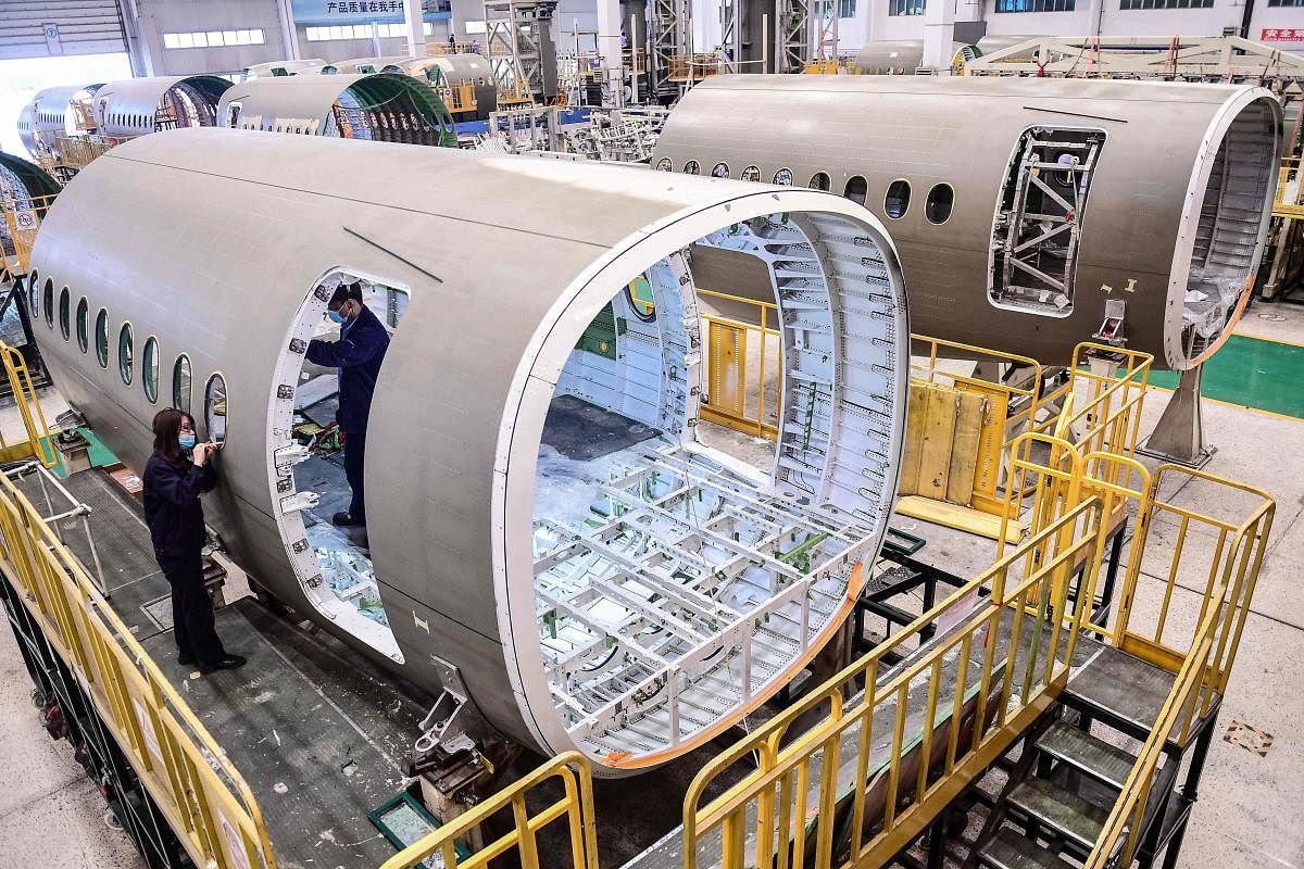 Chinese employees work on the fuselage of Airbus A220 aircraft at a factory in Shenyang in China's northeastern Liaoning province on May 25, 2020.  (AFP Photo)