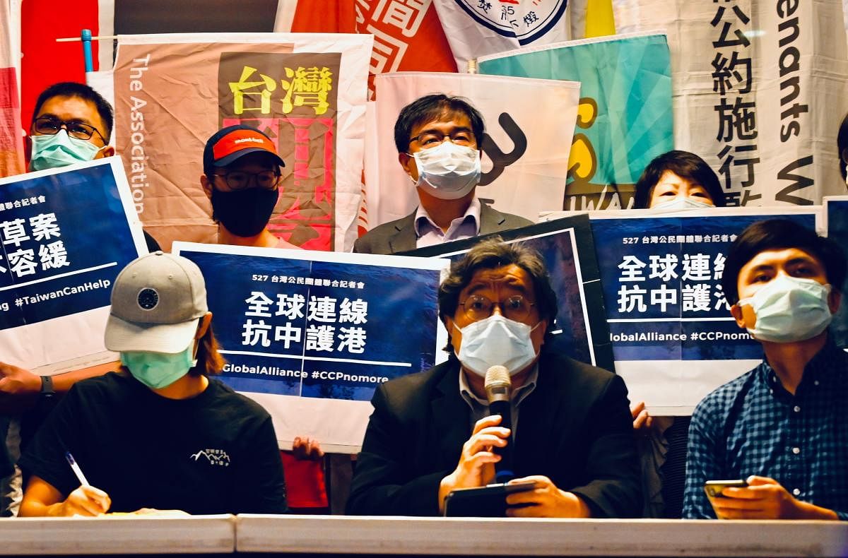 Hong Kongers who live in Taiwan and Taiwanese who support Hong Kong’s freedom display placards reading “Heaven will not tolerate to destroy Hong Kong“ during a press conference organized by Hong Kong Outlanders in Taipei on May 27, 2020. (Photo by Sam Yeh / AFP)
