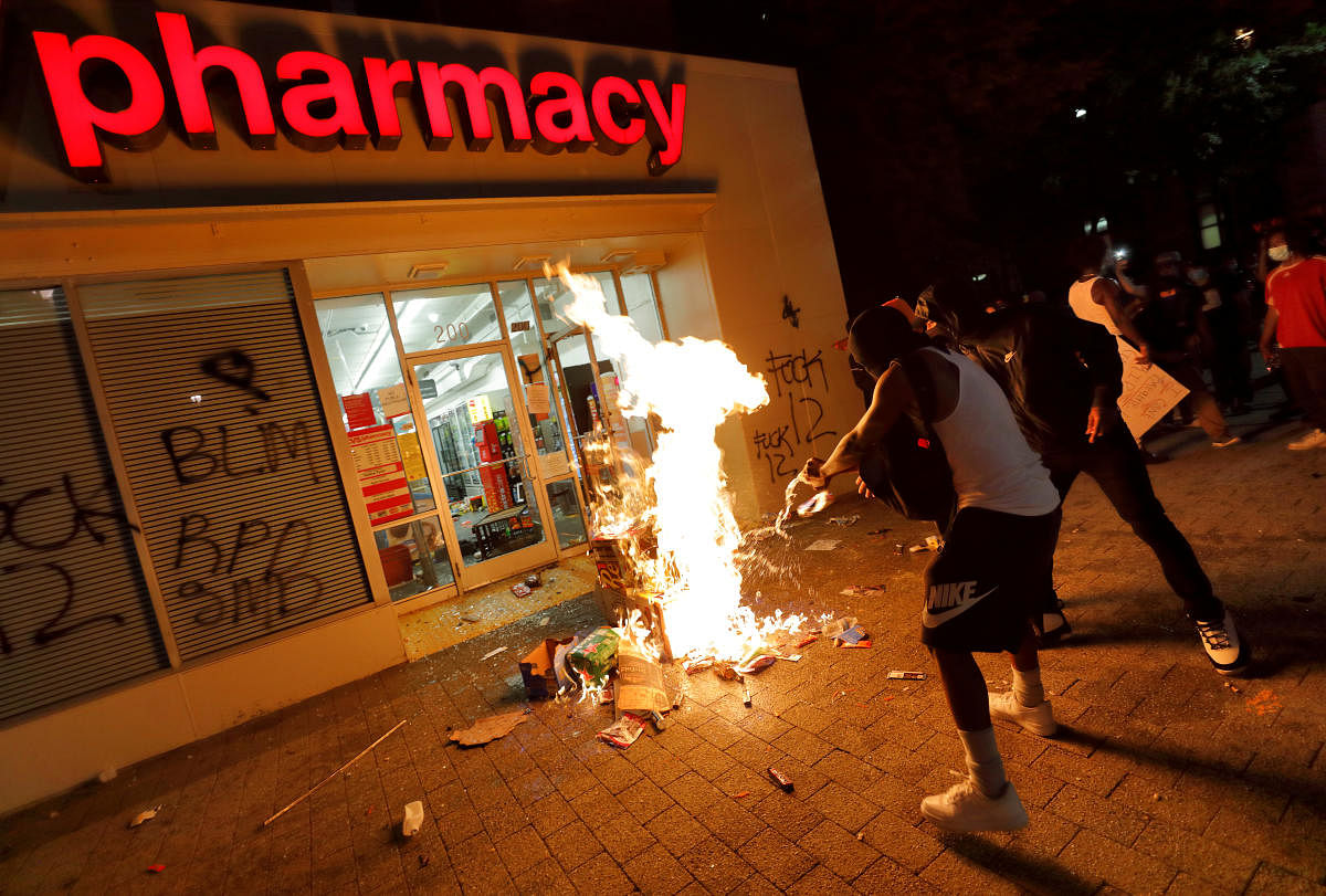People set fire to items looted from a CVS Pharmacy during nationwide unrest following the death in Minneapolis police custody of George Floyd, in Raleigh, North Carolina, U.S. May 30, 2020. Picture taken May 30, 2020. REUTERS