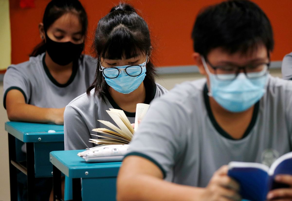 Students wearing protective face masks read in class at Yio Chu Kang Secondary School, as schools reopen amid the coronavirus disease (COVID-19) outbreak in Singapore. (Credit: Reuters Photo)