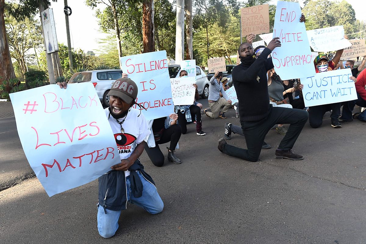 Protesters kneel during a demonstration in solidarity with the global Black Lives Matter movement as they protest over police brutality and white supremacy in the United States (US), Kenya and globally, outside the US Embassy in Nairobi. (Credit: AFP Photo)