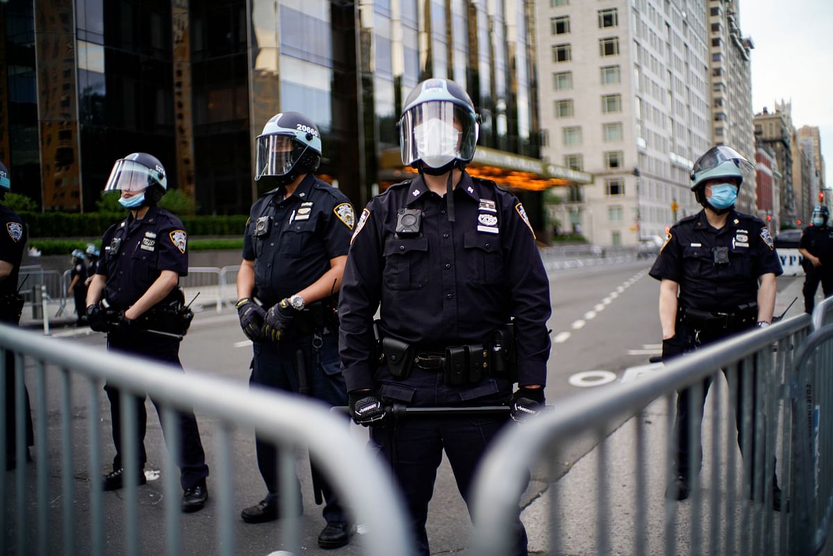 Police officers stand guard during a protest against the death in Minneapolis police custody of George Floyd, in New York City. Credit: Reuters