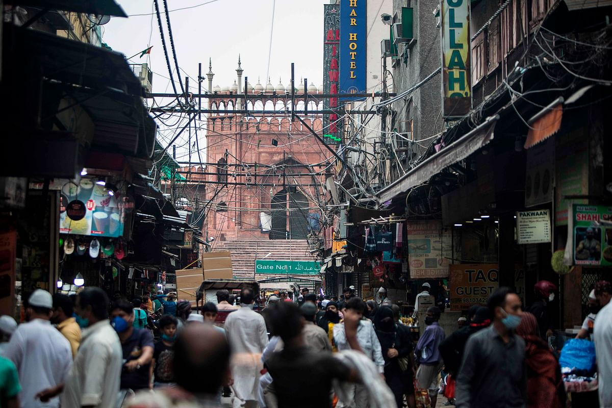 People walk along a street outside the Jama Masjid after the government eased a nationwide lockdown imposed as a preventive measure against the COVID-19 coronavirus in the old quarters of New Delhi. (AFP Photo)