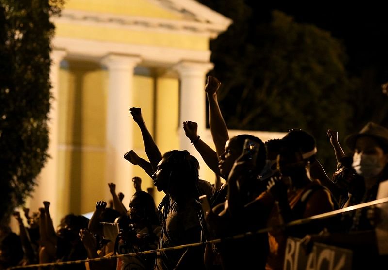 Demonstrators raise their fists in the air near the White House, during a protest against racial inequality in the aftermath of the death in Minneapolis police custody of George Floyd, in Washington, US. (Reuters Photo)